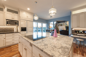 Contemporary finishes include glass cooktop, granite countertops and subway tile backsplash